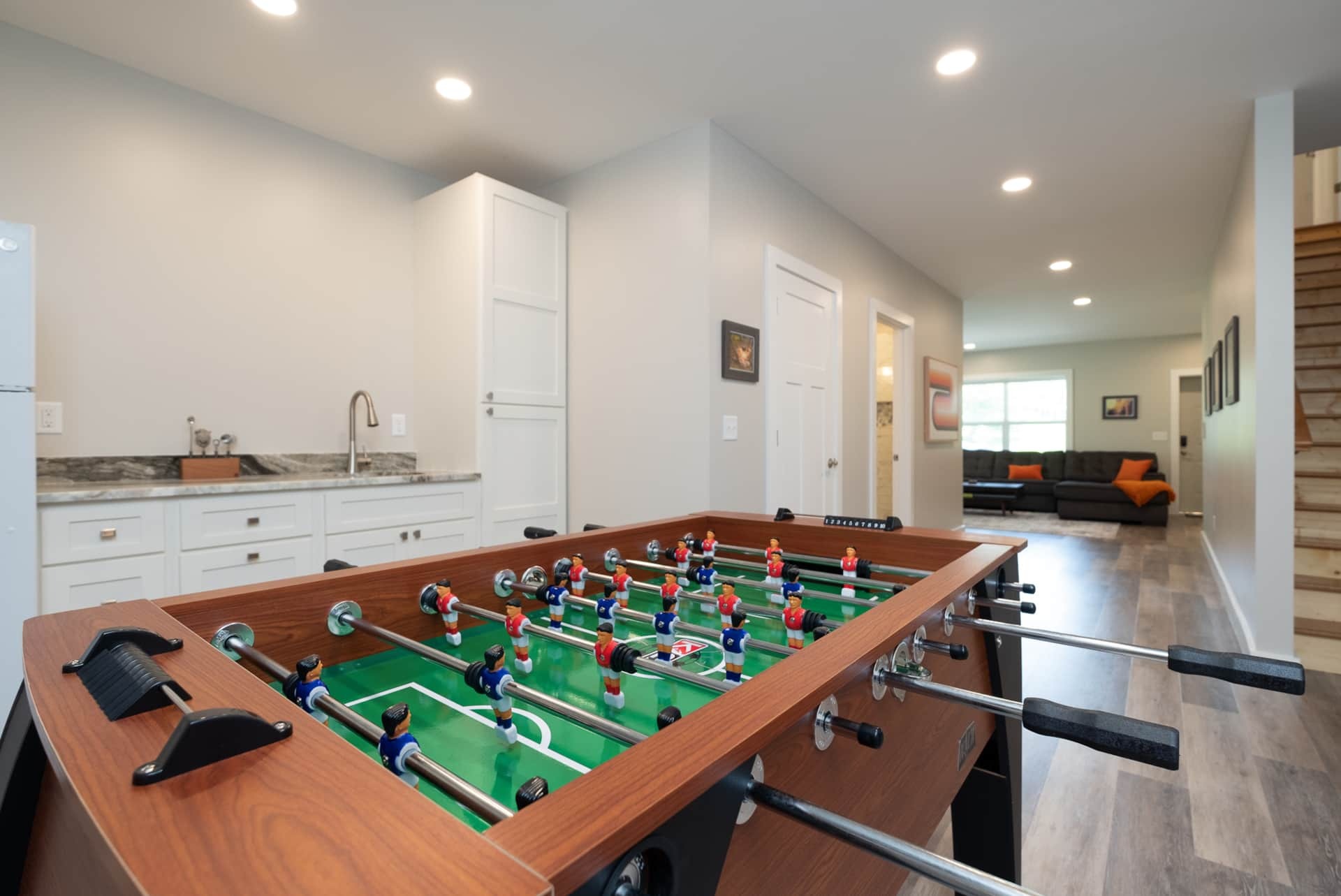 Game room with foosball table, wet bar, and kitchenette
