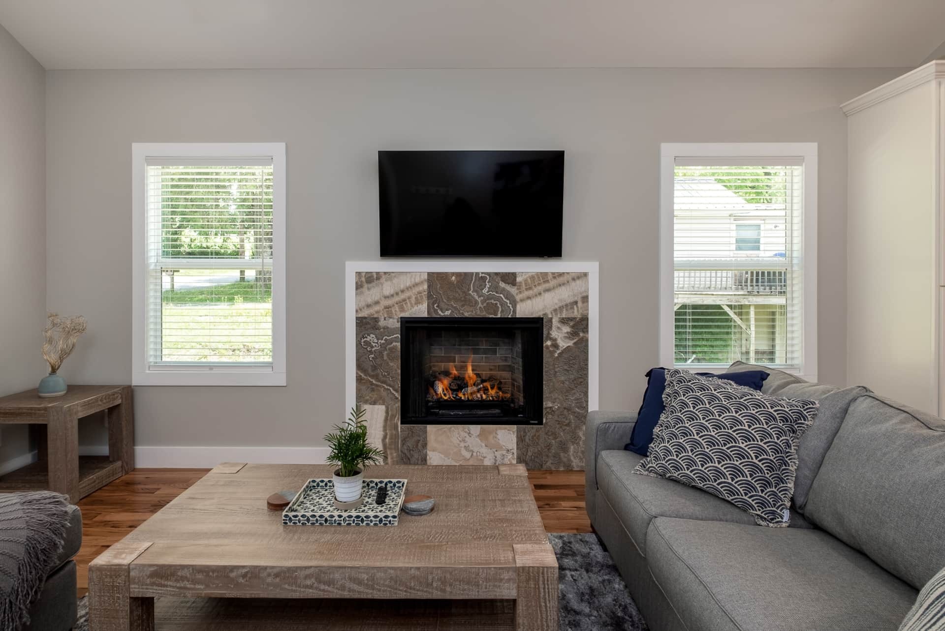 Living room with gray sectional and gas fireplace