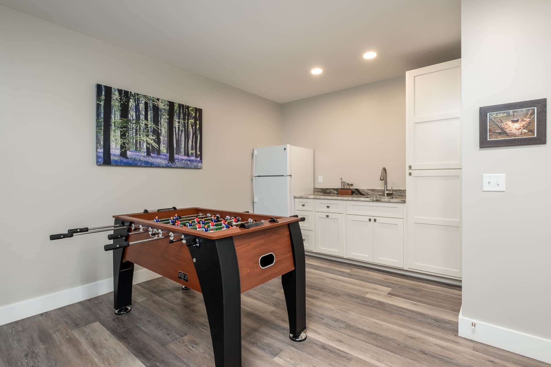 Game room with foosball and forest canvas
