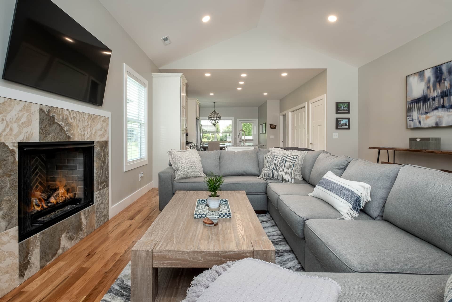 Living room with gray sectional and fireplace