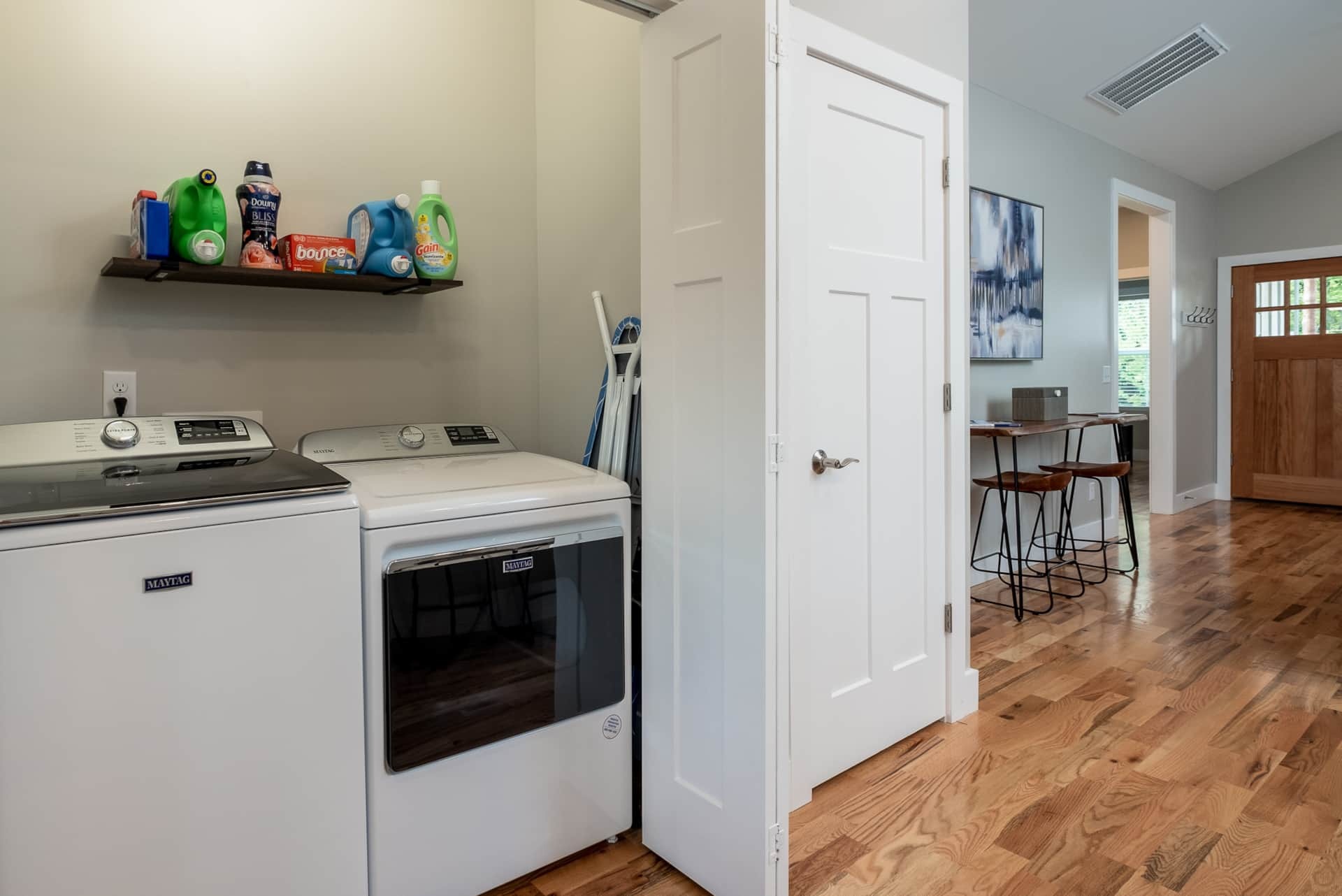 Laundry closet with adjacent bar view