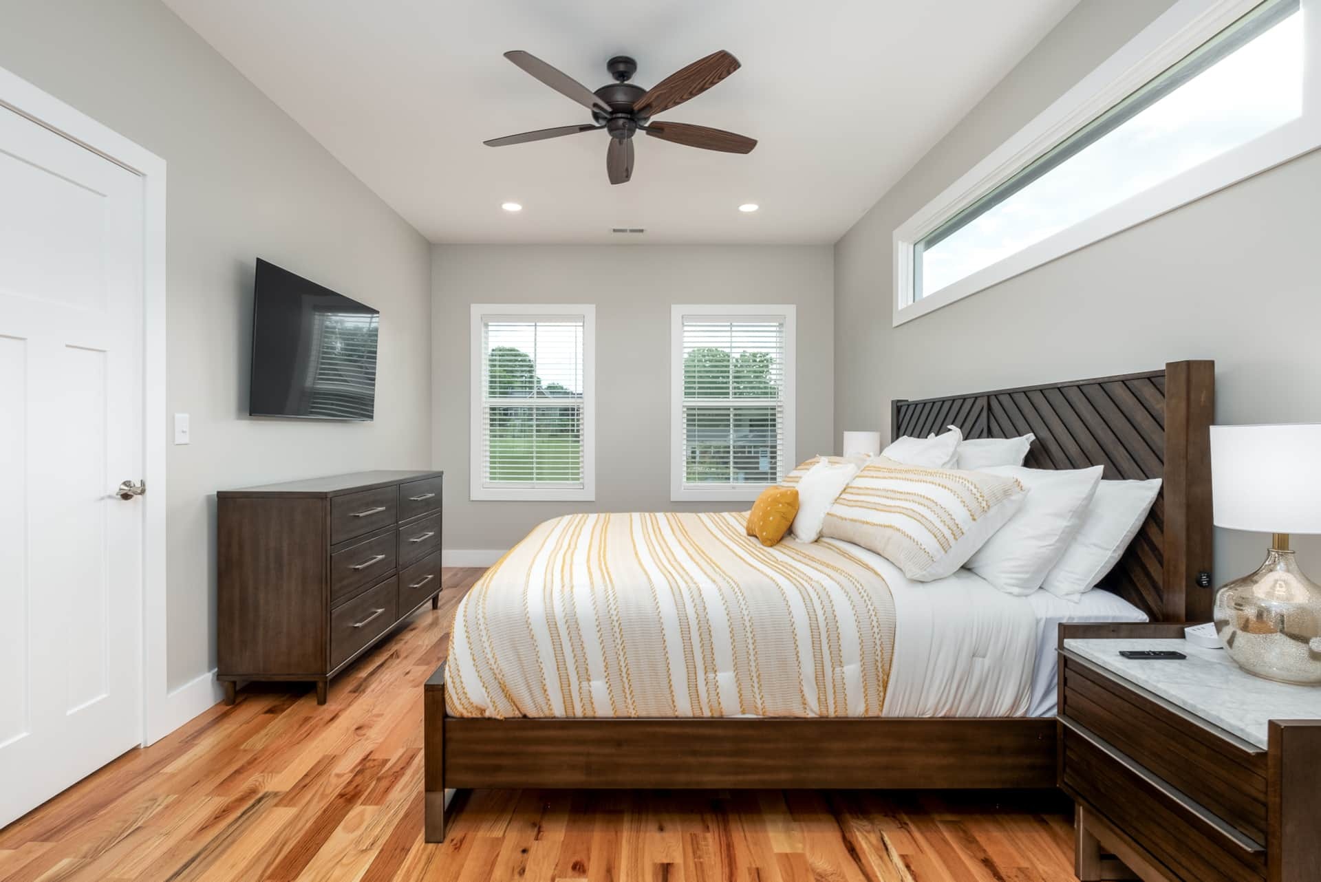 Primary bedroom with king bed and striped duvet