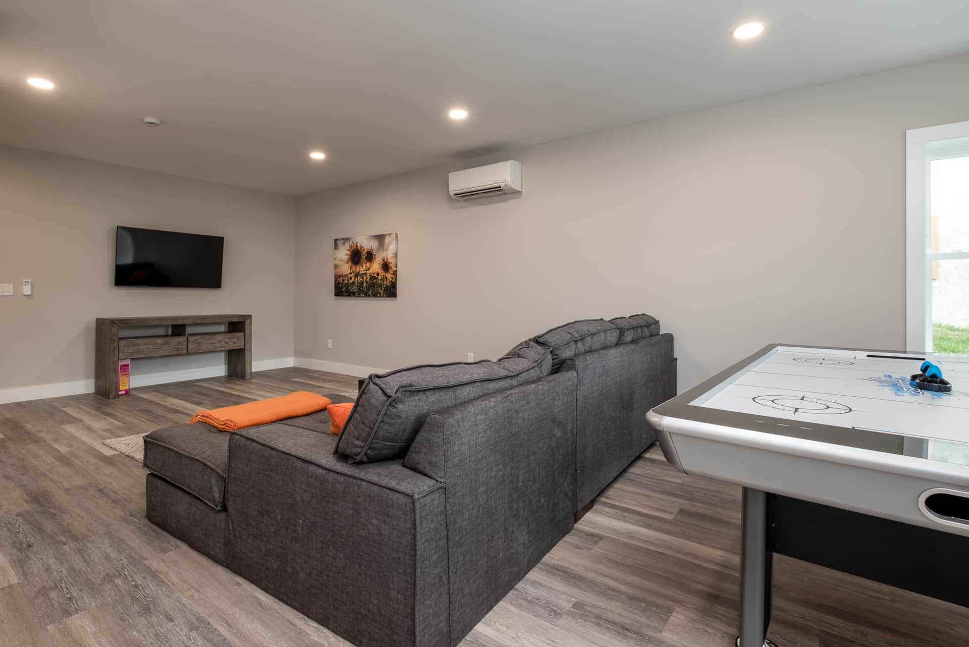 Rec room with sectional and air hockey table