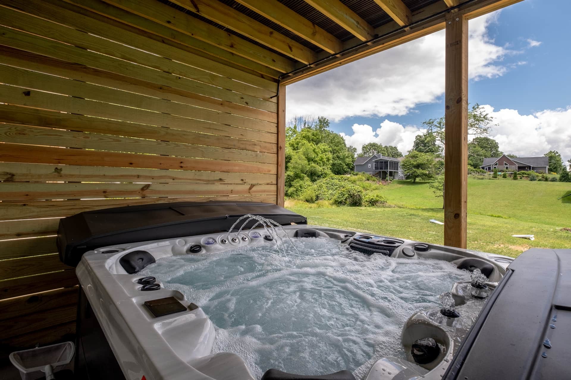 Hot tub on covered deck with cedar slat walls