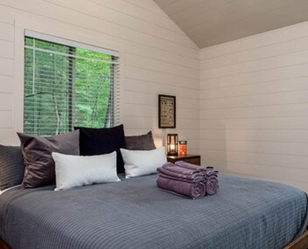 Mirror Cabin exterior reflecting forest