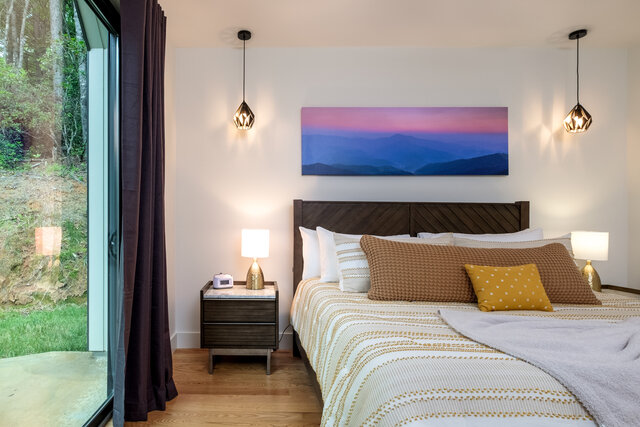 King suite bedroom with mountain artwork