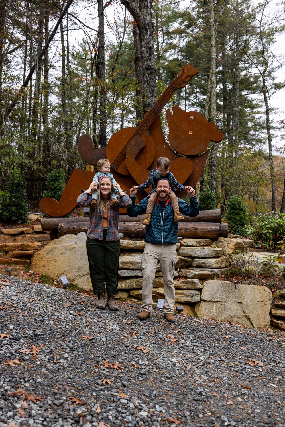 Family at the bear sculpture in fall